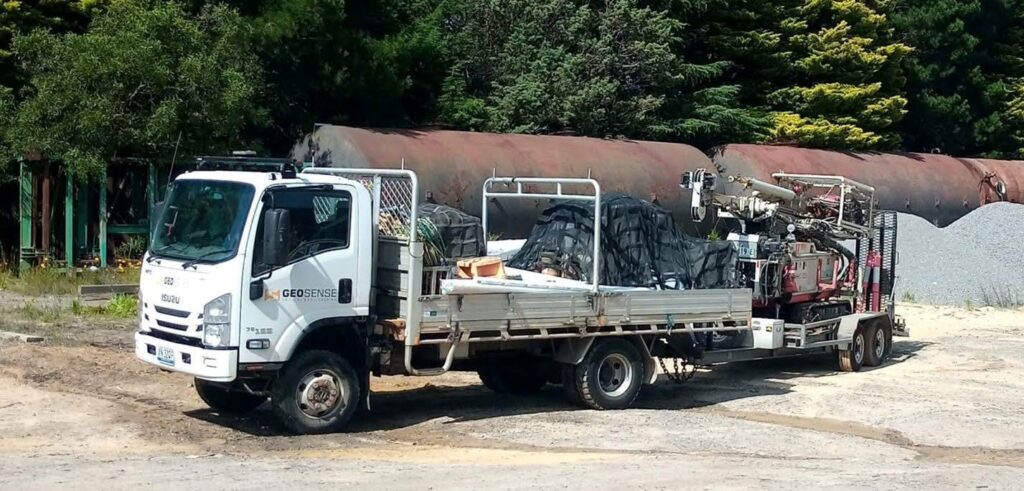 Comacchio GEO205 drilling rig loaded on the Isuzu NPS 75-155 truck and tandem trailer