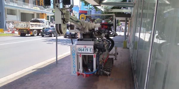 Comacchio GEO205 drilling rig being tracked along a city footpath