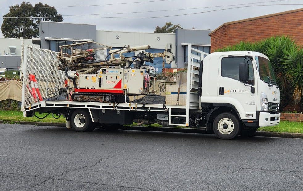Comacchio GEO205 drilling rig loaded on its Isuzu FSR 110-260 carrier truck